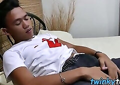 Cute Asian twink sniffs his shoes before jerking on a bed