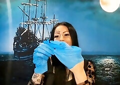 Dominatrix Nika with a glove fetish puts on medical gloves and destroys them with her long tools