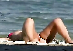 Excited amateur couples are often screwing on the nudist beach, in the centre of the day