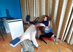 Redheaded office dominatrix humiliates her kneeling employee with foot worship