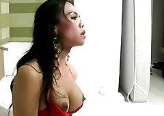 Horny ladyboy in red lingerie inserts beer bottle in her ass