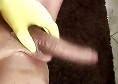 Latina shemale rubs her thick monster cock in yellow gloves
