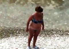 Kinky mature sunbathing wife gets her pussy fingered a bit on the beach