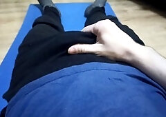 Young dude in green swim trunks enjoys stroking his dick