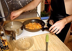 Beautiful cooking. Bare shirtlifter chef is cooking rice noodle with chicken and vegetables