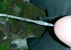 Urinate on the ground outdoor - close up and slow movability - long pee load
