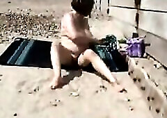 Aged bitch masturbating on a beach !