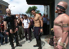 Nick Moretti in a public domination scene with Luke Riley