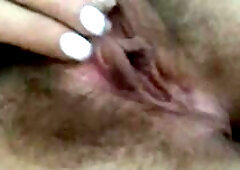 Teen shows off her hairy pussy and rubs her big clit
