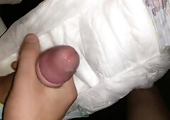 Twink cums in his wet diaper while stroking it solo