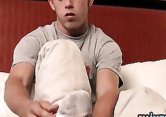 Young gay guy massages his feet and jerks off solo