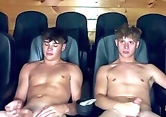 Two guys masturbating in a movie theater.