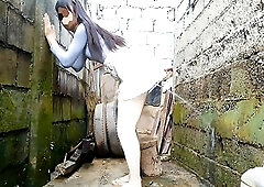 Peeing from behind onto the wall after watching parade