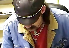 Slender bear with facial hair and lots of rings strokes his meat