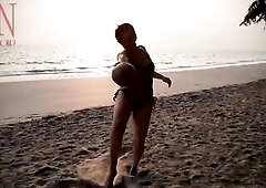 Good lady at lonely nudist beach. Red swimsuit. Red bikini. Coconut