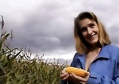 Naughty brunette hair loves masturbating outdoors and filling her one as well as the other holes with a large corn.