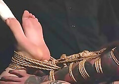 Busty tattooed blonde girl gets hogtied and takes Bastinado session