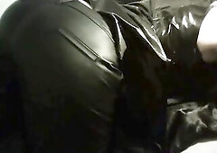A web camera presentation featuring leather-look leggings, a ebony PVC costume, fishnet gloves, and a darksome-haired style. A close look at the outfi