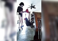 A crossdresser working as a maid and they put her in a bikini strap.