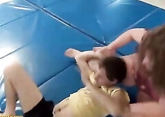 Overweight woman is sitting on top of a slim stud after wrestling with him, a bit