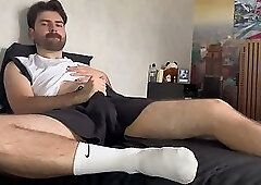 Hairy hunk shows off white socks and oily feet