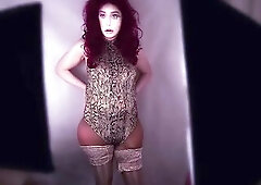 I wear a realistic silicone female mask with a belt leotard bodysuit, shiny nylons, and hose. I pose and show off my large ass