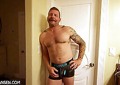 Unshaved beefcake Colby Jansen flaunts his huge dildo collection