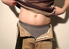 Close up of man undressing and pleasuring his uncut cock until fully erect