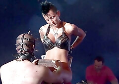 Wild syringe fetish show on public stage featuring extreme unwrapping