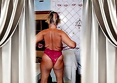 In a cozy, sunny kitchen, a happy old woman with a playful expression on her face and a glad disposition is flirting with a chap, imagining the presen