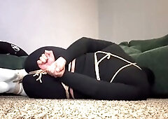 Crossdresser tied up in self-restraint bondage