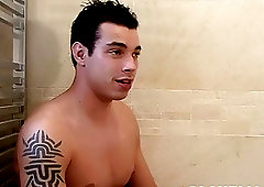 Buff tattooed UK gay Joe Legend wanks his dick in a bathroom