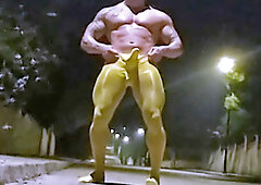 Muscled exhibitionist in spandex strips and cums on public road