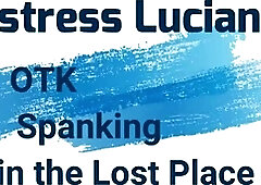 Dominatrix punishes slave with spanking in abandoned place