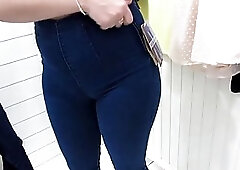 Chubby brunette is changing clothes and pissing in front of a hidden camera, in the mall