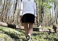 Pretty woman walking stripped with a clitoris pump outdoors in a public forest