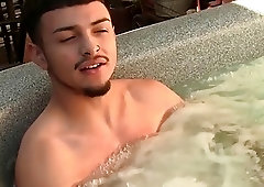 Latino jock tugs on his massive boner in a jacuzzi