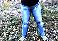 Breasty big beautiful woman walks in a public park and craves to piddle. This Babe tries to unbutton her jeans, but this babe can't. Mother I