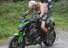 Two Muscular Guys On A Green Motorcycle