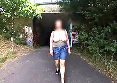 A huge-chested cougar ambling in public bare-chested