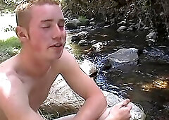 Forest twink masturbates near the stream
