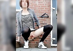 Clothed up and pee outdoor in suit and sneakers