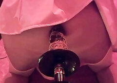 Michelle in a pink petticoat gets in the ass by the machine.