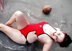 Worthwhile lady at lonely nudist beach. Red swimsuit. Red bikini. Coconut
