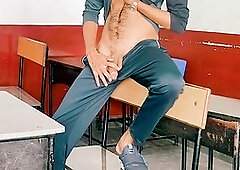 Naughty twink jerking off his big cock in a wild classroom adventure