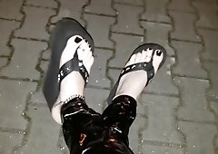 crossdresser on a public street in spandex stretch pants and cool platform roll flops