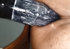 Black man rides a thick dildo