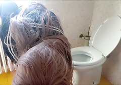 Pink-haired woman exposes herself and urinates in a tiled bathroom