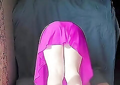 Playful femboy teasing with skirt in windy street