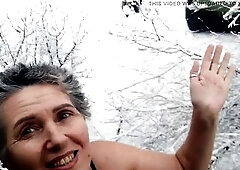 Winter dreams, dreamy eyes with a enchanting smile, white snow and red linen. Takes off raiment. Red pants, fishnet nylons are a spectacle for voyeurs